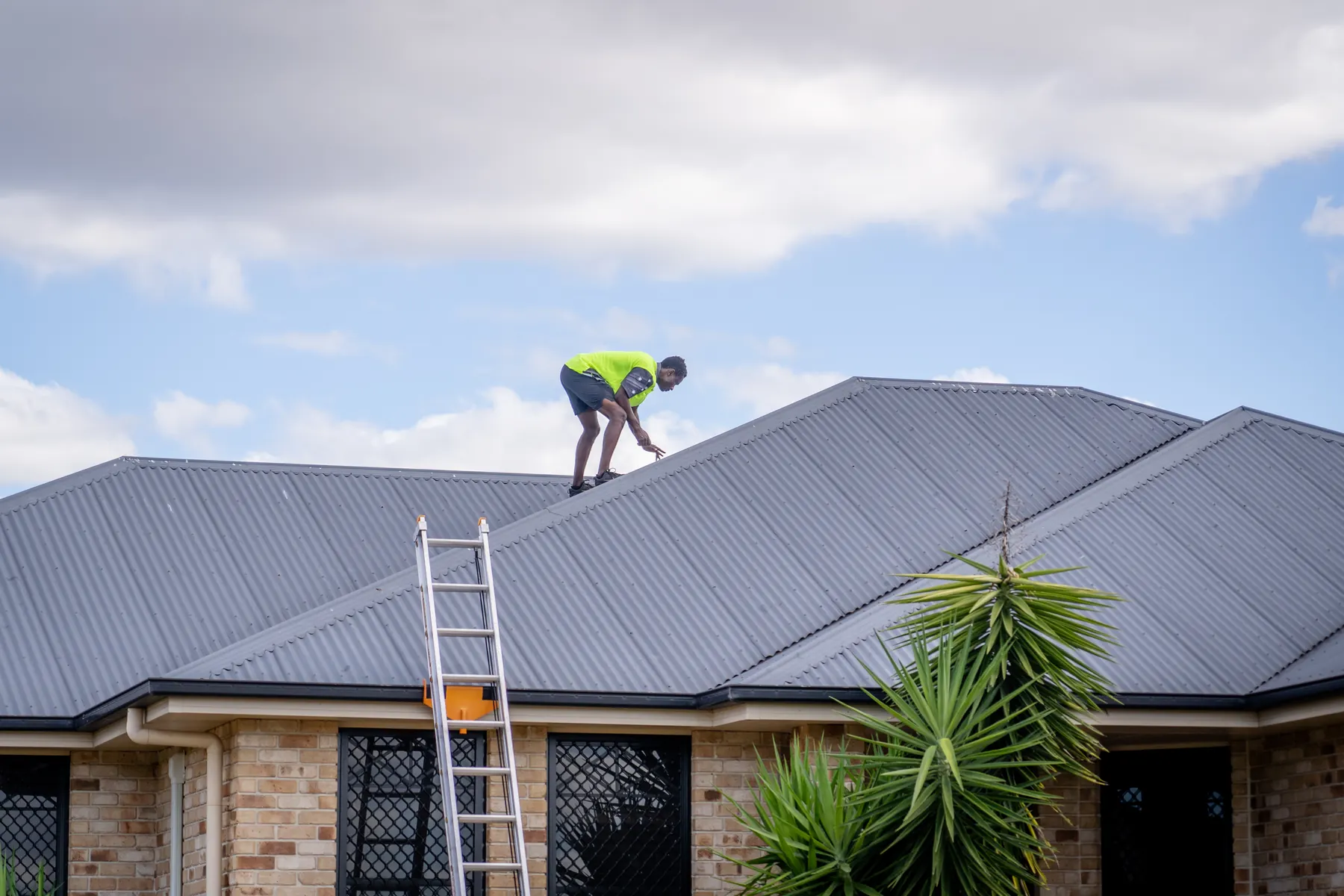 Inspector on a roof pointing out affected areas
